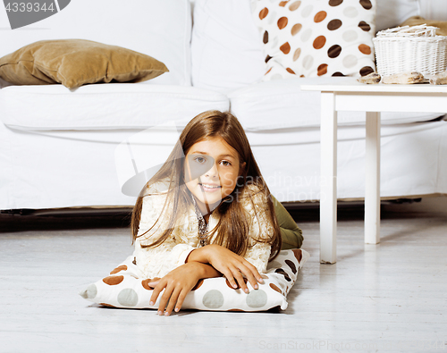 Image of little cute brunette girl at home interior happy smiling close u