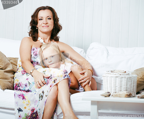 Image of Portrait of smiling young mother and daughter at home, happy fam