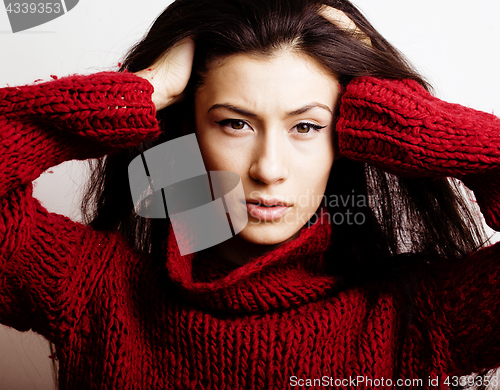 Image of young pretty woman in sweater and scarf all over her face, lifes