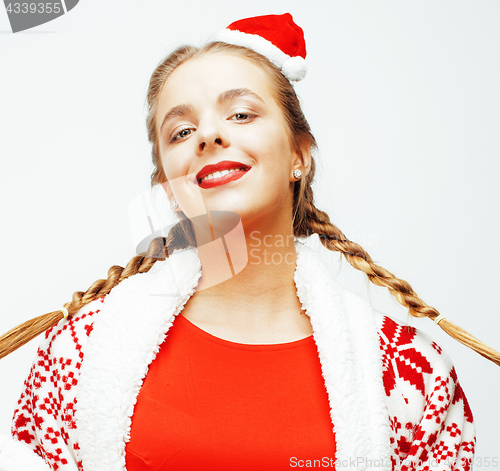 Image of young pretty happy smiling blond woman on christmas in santas red hat and holiday decorated plaid, lifestyle people concept