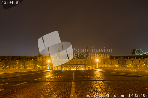 Image of Bridge by the Seine river in Paris at night