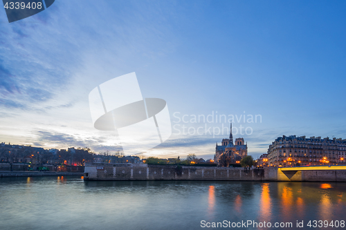 Image of Notre Dame Cathedral with Paris cityscape at dus