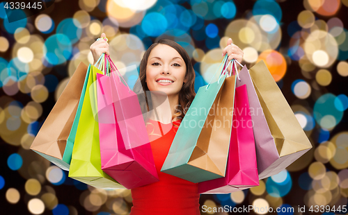 Image of happy woman with colorful shopping bags
