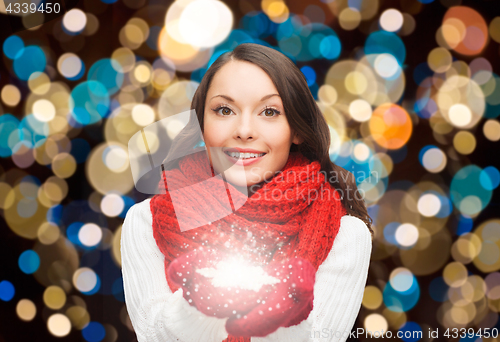 Image of woman in scarf with christmas magic snowflake