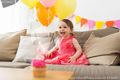 Image of happy baby girl on birthday party at home