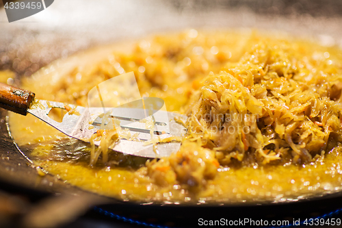 Image of braised cabbage or sauerkraut in wok or frying pan