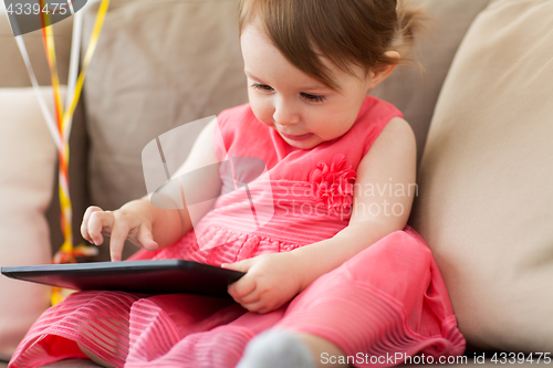 Image of baby girl with tablet pc at home
