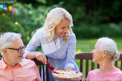 Image of happy family having dinner or summer garden party