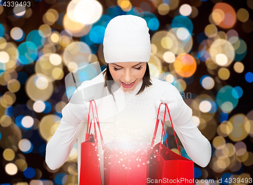 Image of woman in winter hat with christmas shopping bags