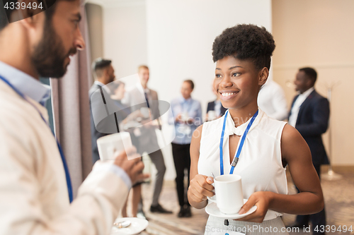 Image of business people with conference badges and coffee