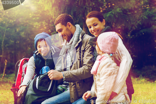 Image of happy family drinking hot tea at camp