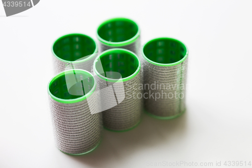 Image of green hair curlers or rollers