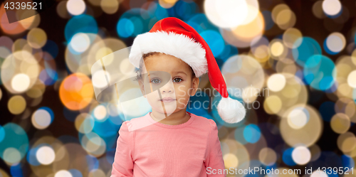 Image of little baby girl in santa hat at christmas
