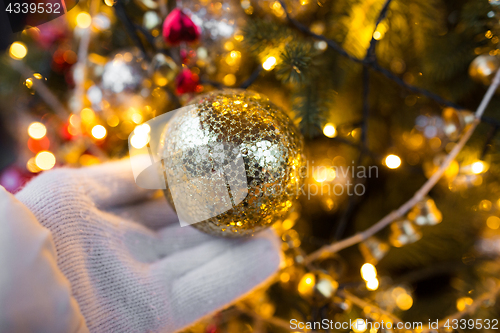 Image of close up of hand with christmas tree toy