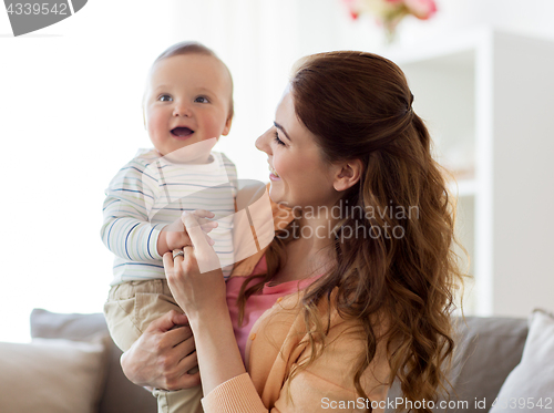 Image of happy young mother with little baby at home