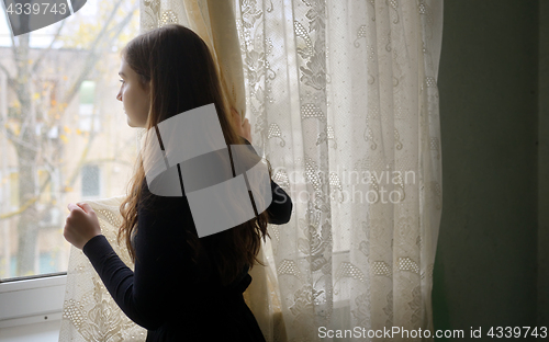 Image of Young girl in black vintage dress 