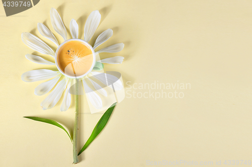 Image of Cup of coffee and petals create flower