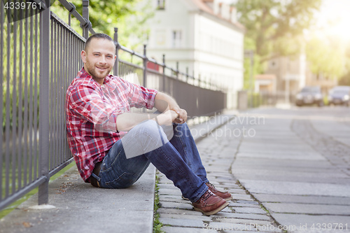 Image of bearded handsome man relaxing at the street