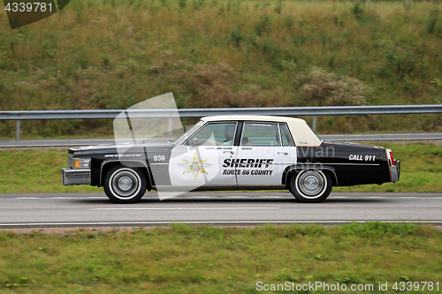 Image of Classic Cadillac Police Vehicle on Road