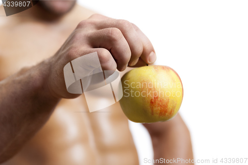 Image of an apple holding by a male hand