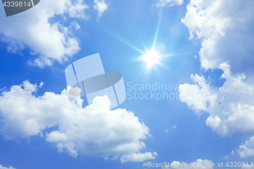 Image of blue sky with sun and clouds background