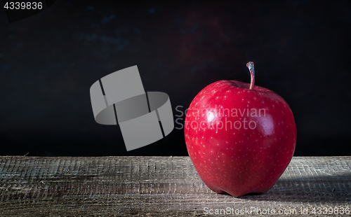 Image of Single apple on a wooden table