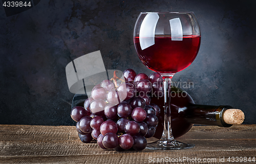 Image of Glass wine with grapes and bottle