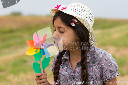 Image of Smiling girl with pinwheel