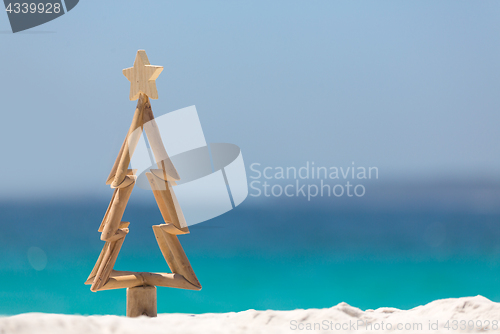 Image of Timber Christmas tree in sand on the beach