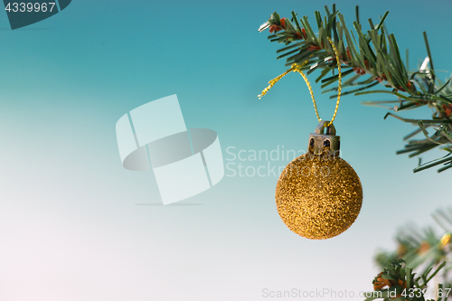 Image of Gold glitter bauble on Christmas tree