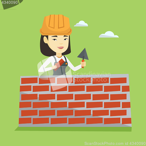 Image of Bricklayer working with spatula and brick.