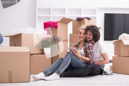 Image of young couple moving  in new house