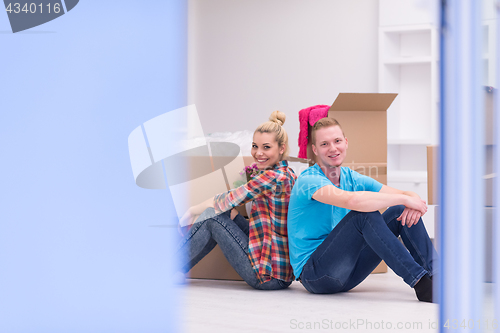 Image of young couple moving  in new house