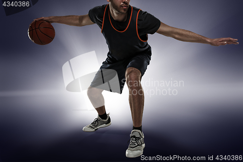 Image of Full length portrait of a basketball player with ball