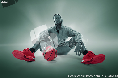 Image of Full length portrait of a basketball player with ball