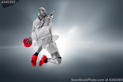 Image of Full length portrait of a basketball player with ball