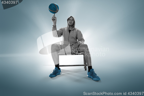 Image of Full length portrait of a basketball player with ball