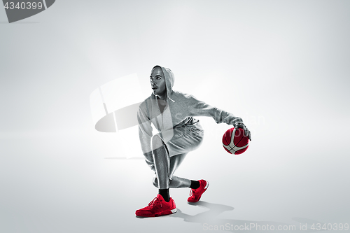 Image of Full length portrait of a basketball player with ball