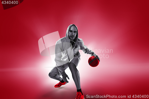 Image of Full length portrait of a basketball player with ball