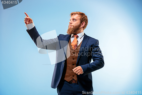 Image of Portrait of a business man isolated on blue background.