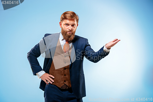 Image of Portrait of a business man isolated on blue background.