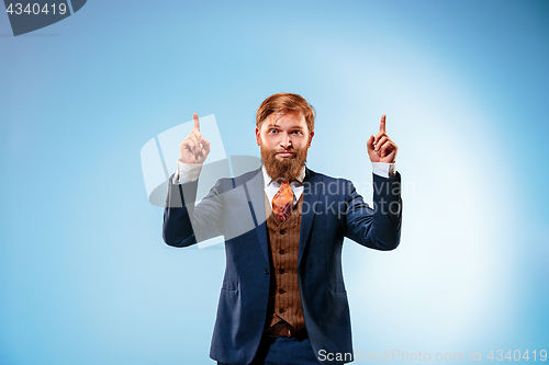 Image of Portrait of a business man isolated on blue background.