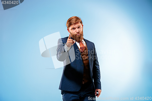 Image of Portrait of a business man isolated on blue background.