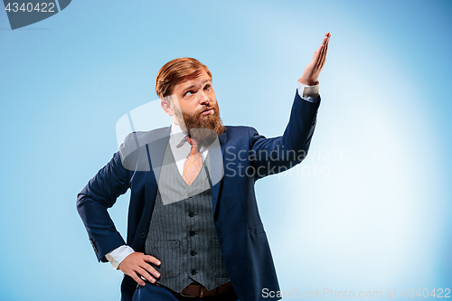 Image of Portrait of a business man isolated on blue background.