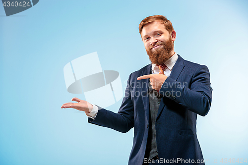 Image of Portrait of a business man isolated on blue background.