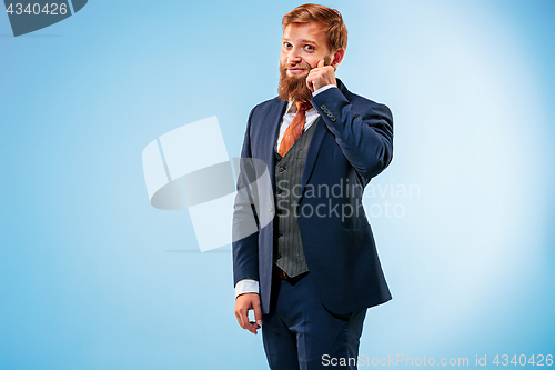 Image of Portrait of a business man isolated on blue background.