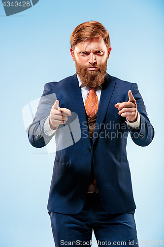 Image of Portrait of a business man isolated on blue background.