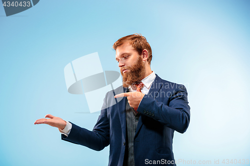 Image of Portrait of a business man isolated on blue background.