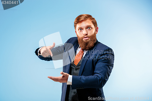 Image of Portrait of a business man isolated on blue background.