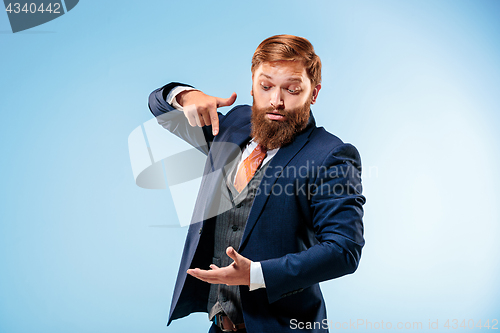 Image of Portrait of a business man isolated on blue background.